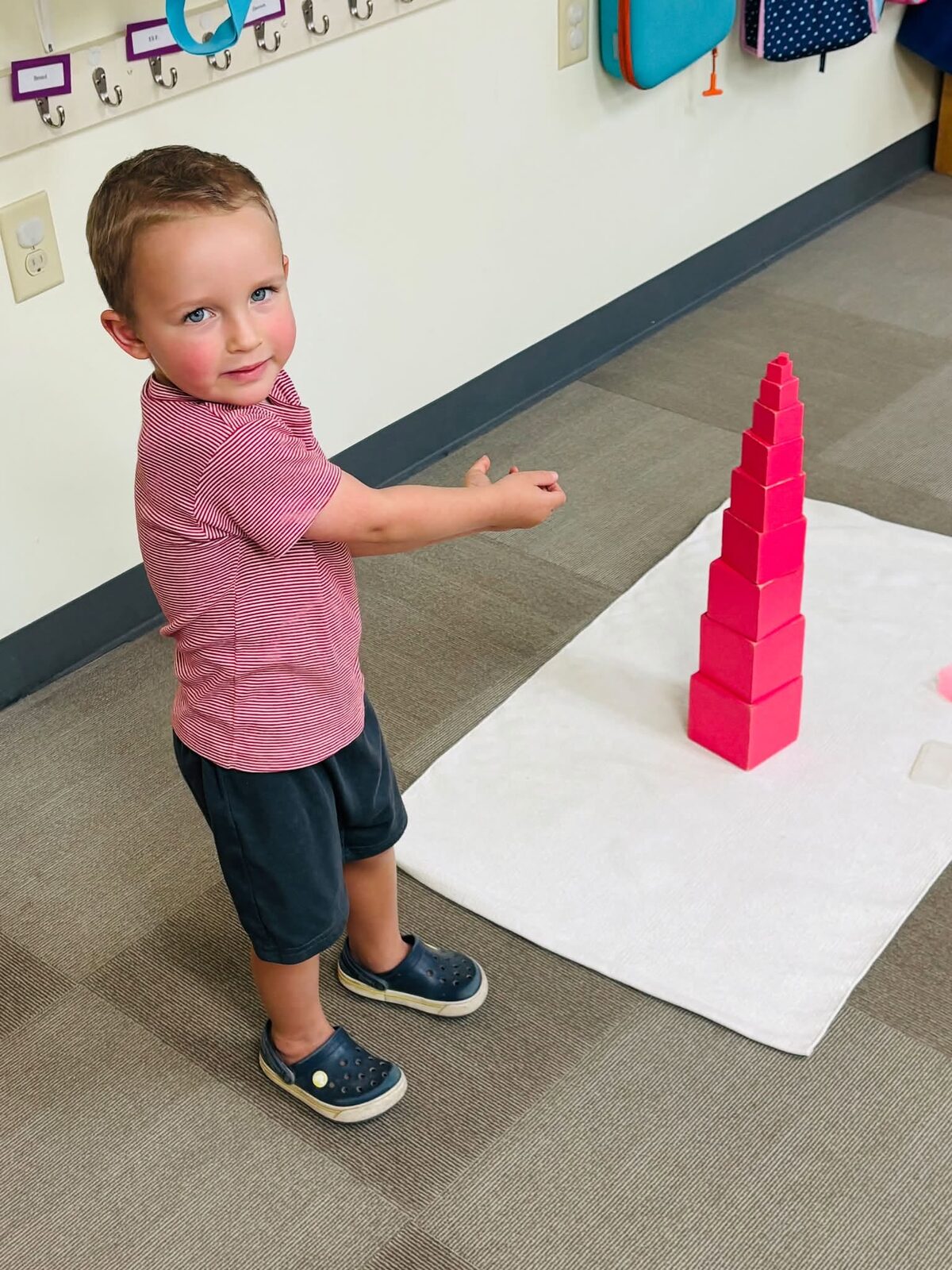Primary classroom children working independently with Montessori materials